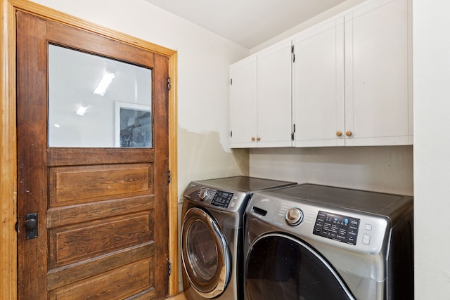 laundry area featuring cabinets and washing machine and clothes dryer