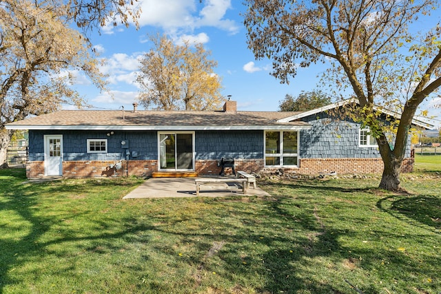 back of house featuring a patio and a lawn