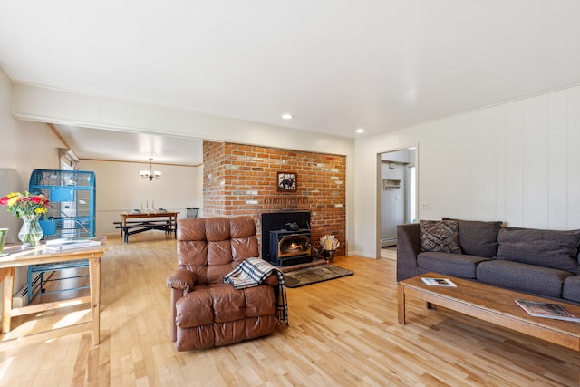 living room with a wood stove and light hardwood / wood-style floors