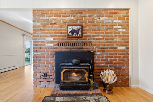 room details featuring a wood stove, hardwood / wood-style floors, and a baseboard heating unit