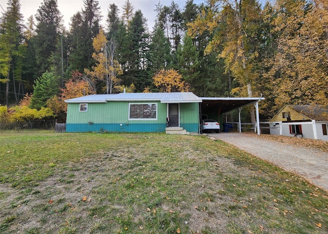 33762 US Highway 2, Libby, MT 59923 - manufactured / mobile home featuring gravel driveway, a metal roof, and an attached carport