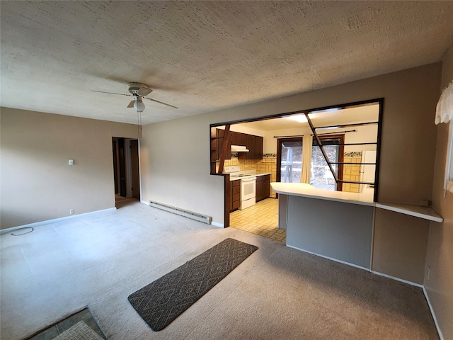 interior space featuring baseboard heating, light carpet, a textured ceiling, and ceiling fan