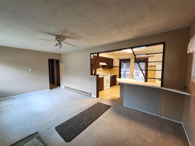 33762 US Highway 2, Libby, MT 59923 - unfurnished living room with baseboard heating, light carpet, ceiling fan, and a textured ceiling