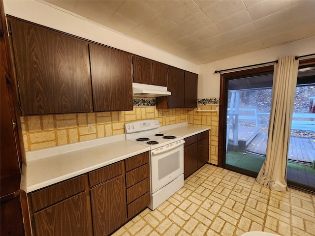 33762 US Highway 2, Libby, MT 59923 - kitchen featuring white electric range, under cabinet range hood, light countertops, brick patterned flooring, and dark brown cabinetry