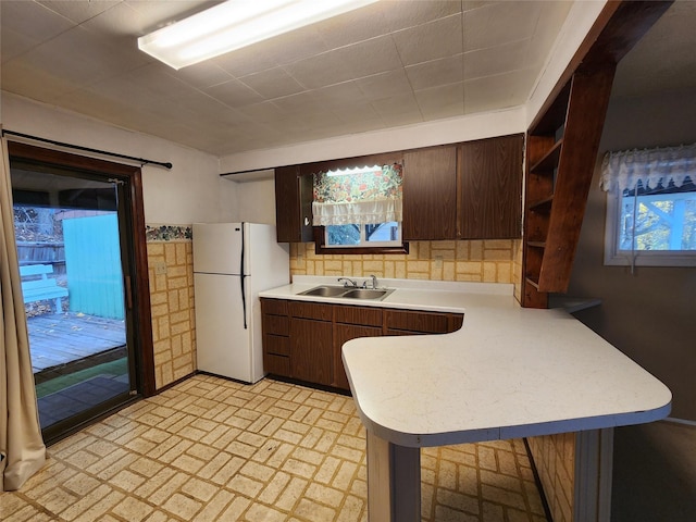 33762 US Highway 2, Libby, MT 59923 - kitchen with freestanding refrigerator, open shelves, a peninsula, light countertops, and dark brown cabinetry
