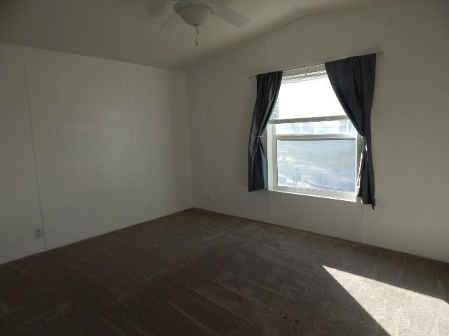 2922 Village Rd, Helena, MT 59602 - empty room with lofted ceiling, a ceiling fan, and carpet flooring