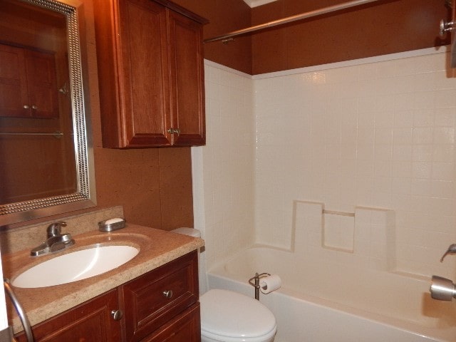 full bathroom featuring toilet, shower / bathing tub combination, and vanity