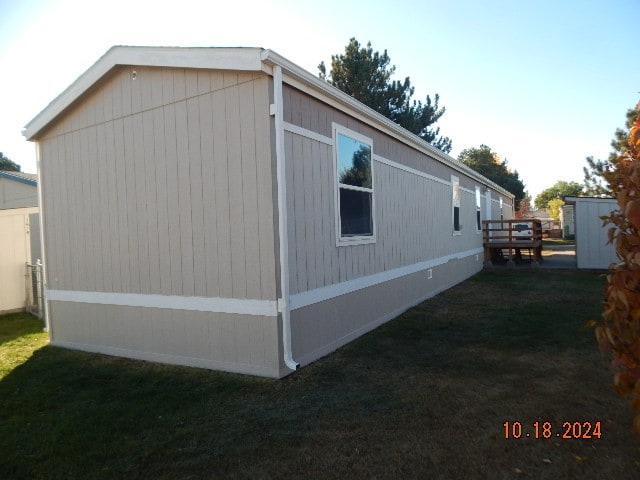 view of property exterior featuring a lawn