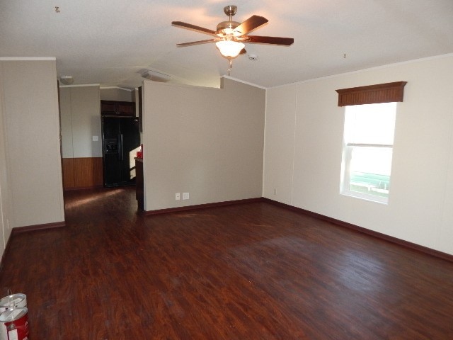 empty room with dark wood-type flooring and ceiling fan