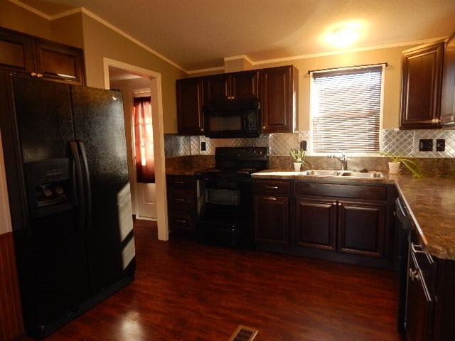 kitchen featuring decorative backsplash, ornamental molding, sink, black appliances, and dark hardwood / wood-style flooring