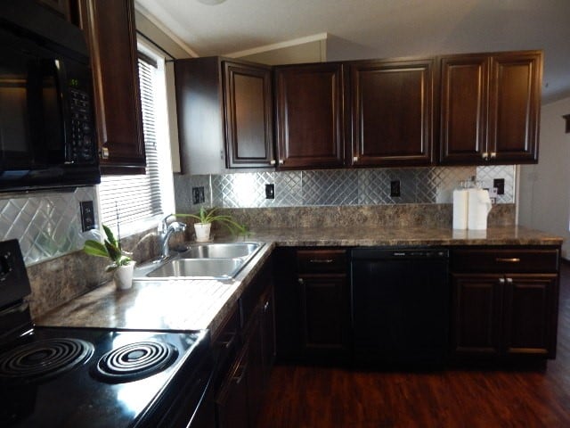 kitchen with tasteful backsplash, black appliances, sink, and dark hardwood / wood-style flooring