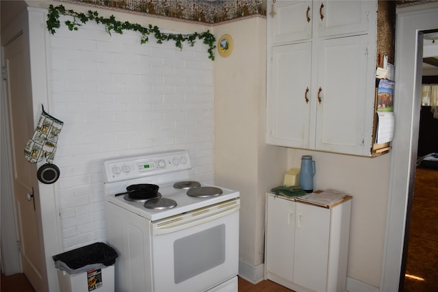 kitchen with white cabinetry and white electric stove