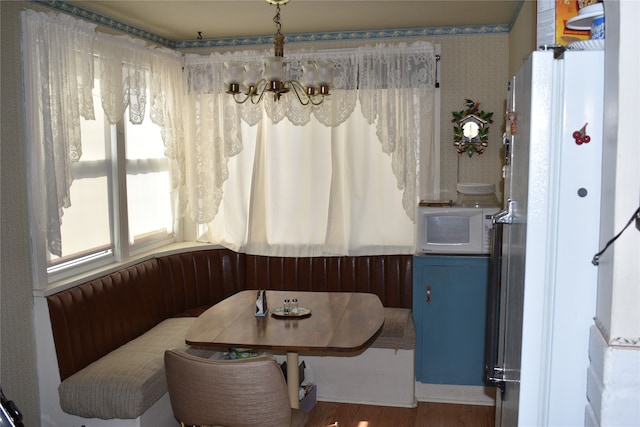 dining area with breakfast area and dark hardwood / wood-style flooring