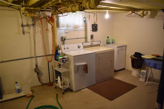 clothes washing area with separate washer and dryer