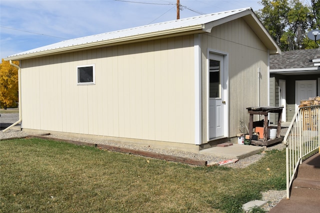 view of side of home with a yard