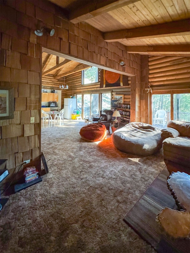 living room with wood ceiling, a healthy amount of sunlight, beamed ceiling, and carpet flooring