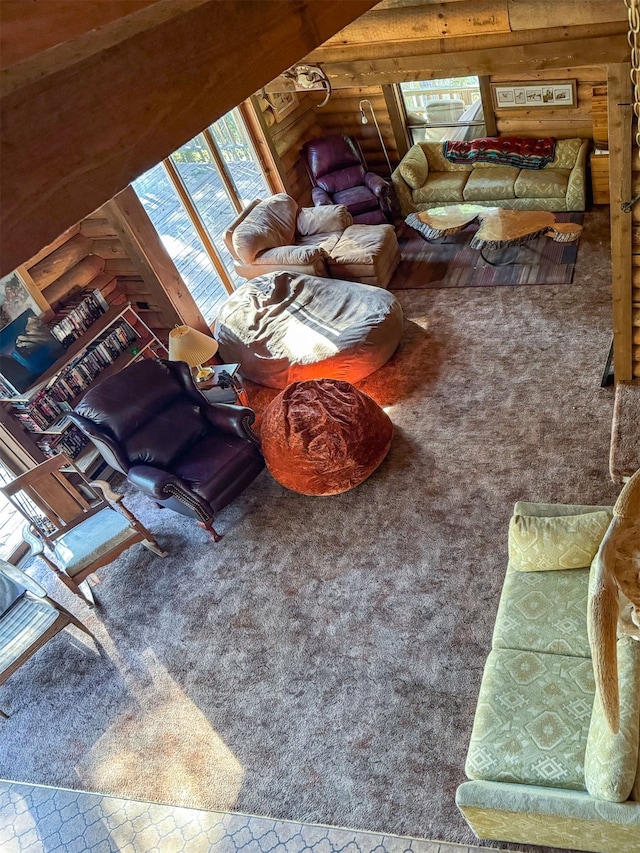 carpeted living room featuring wooden walls and vaulted ceiling