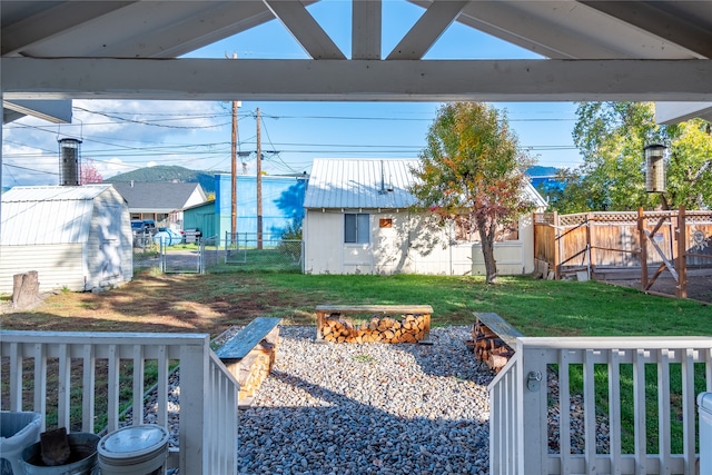 view of yard with a shed and a fire pit