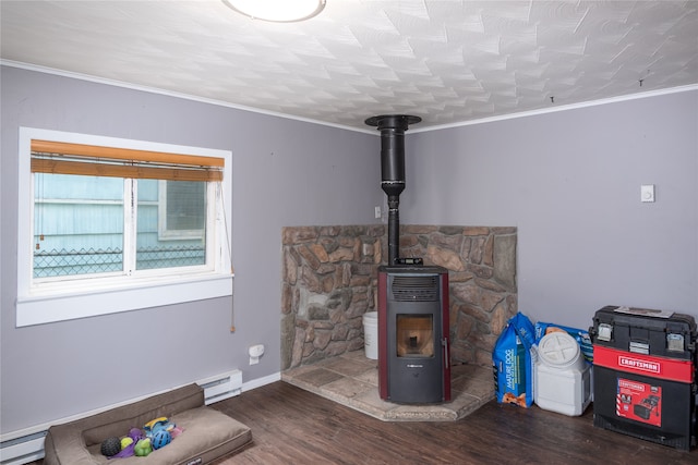 living room featuring ornamental molding, a wood stove, a baseboard heating unit, and dark hardwood / wood-style floors