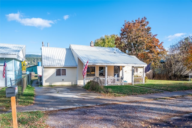 view of front of property with a front yard and covered porch