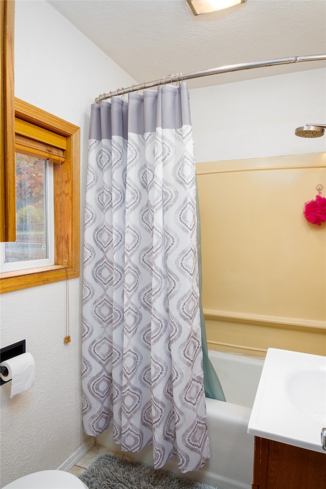 bathroom featuring vanity and shower / bathtub combination with curtain