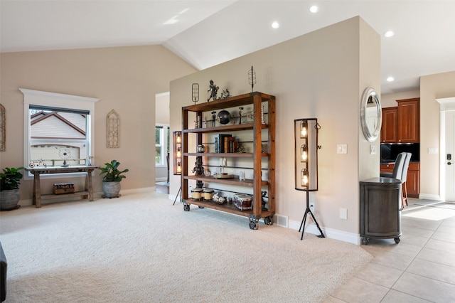 10636 Nez Perce Loop, Lolo, MT 59847 - living area with lofted ceiling, recessed lighting, light colored carpet, and light tile patterned flooring