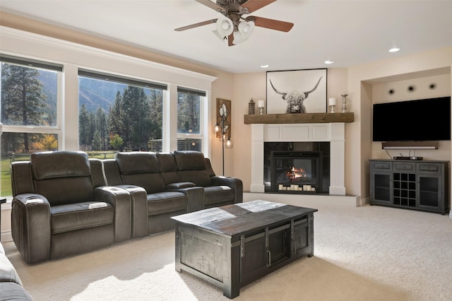 10636 Nez Perce Loop, Lolo, MT 59847 - living room with light colored carpet, ceiling fan, a tiled fireplace, and recessed lighting