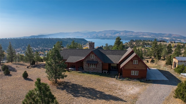 4025 Sunset Ridge Dr, Helena, MT 59602 - view of front of house featuring a chimney, a mountain view, and stone siding