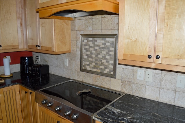 4025 Sunset Ridge Dr, Helena, MT 59602 - kitchen with electric stovetop, under cabinet range hood, and decorative backsplash