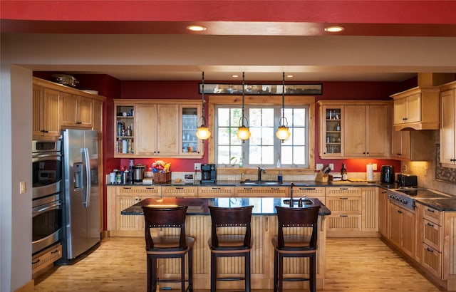 4025 Sunset Ridge Dr, Helena, MT 59602 - kitchen featuring appliances with stainless steel finishes, dark countertops, light wood-style floors, and a sink
