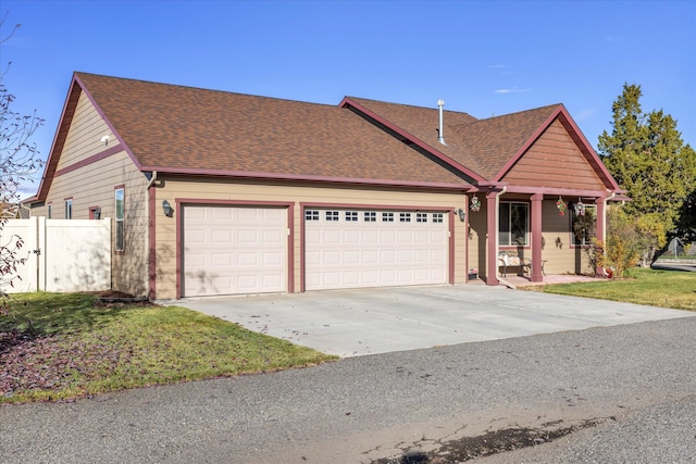 view of front of property featuring a front yard and a garage