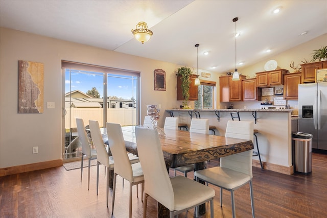 dining area with lofted ceiling and dark hardwood / wood-style floors