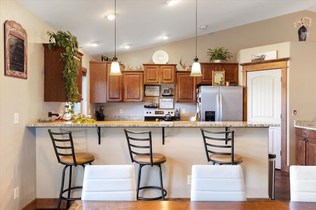 kitchen with lofted ceiling, stainless steel fridge with ice dispenser, light stone counters, and pendant lighting