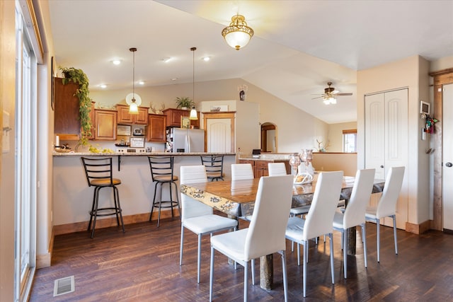 dining room featuring lofted ceiling, dark hardwood / wood-style floors, and ceiling fan