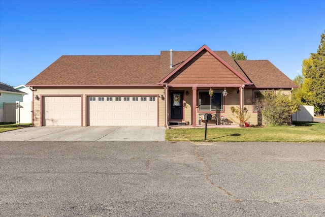 view of front of property with covered porch and a garage