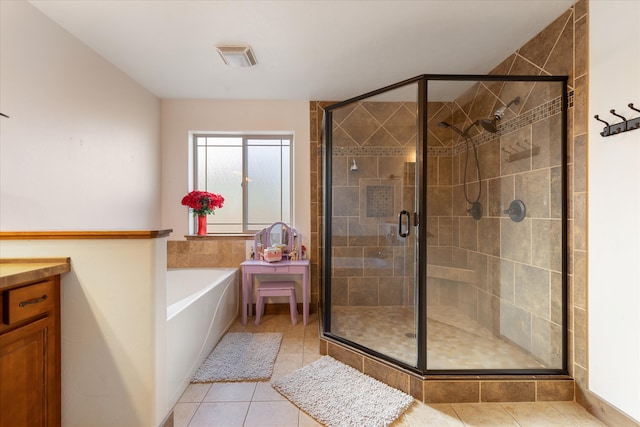 bathroom featuring vanity, tile patterned floors, and shower with separate bathtub