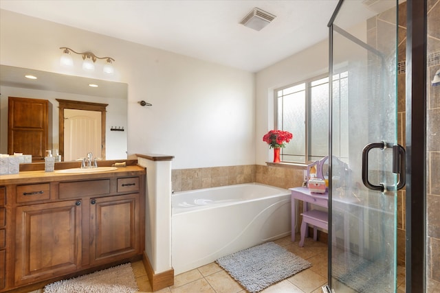 bathroom with vanity, independent shower and bath, and tile patterned flooring