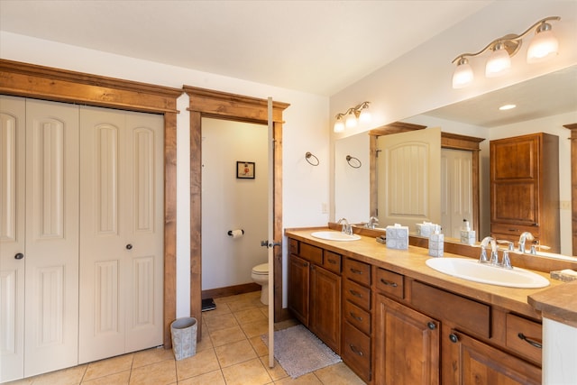 bathroom featuring vanity, toilet, and tile patterned flooring