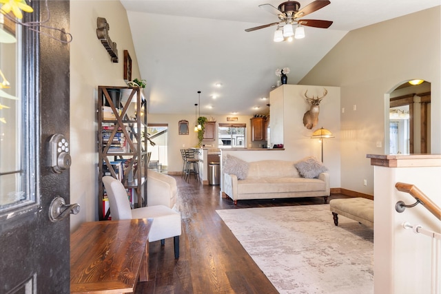 living room with lofted ceiling, dark wood-type flooring, and ceiling fan