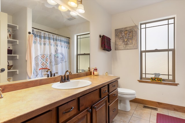 bathroom with vanity, toilet, and tile patterned flooring