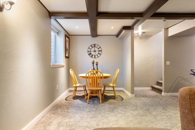 carpeted dining area with beam ceiling and coffered ceiling