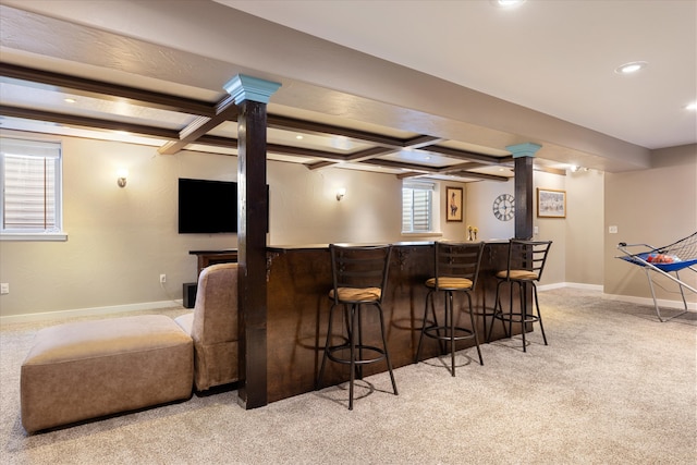 carpeted cinema with beam ceiling, coffered ceiling, and indoor bar