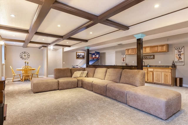 carpeted living room with wet bar, beamed ceiling, coffered ceiling, and ornate columns