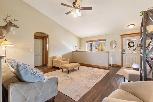 living room featuring lofted ceiling, ceiling fan, and dark hardwood / wood-style flooring