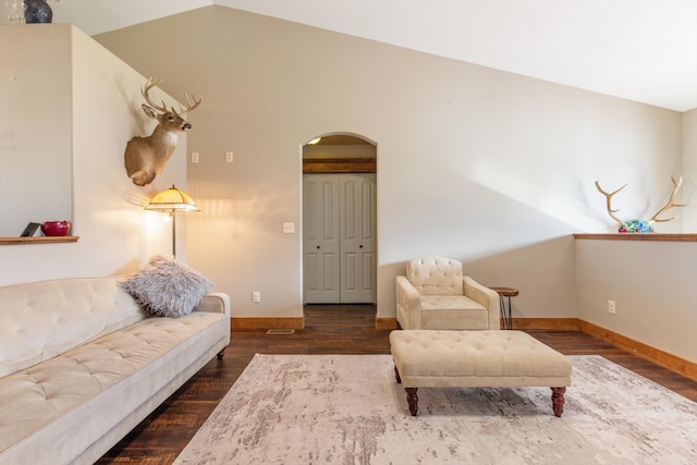 living room featuring lofted ceiling and dark hardwood / wood-style floors