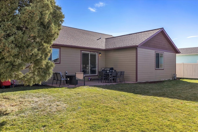 rear view of property featuring a patio and a lawn