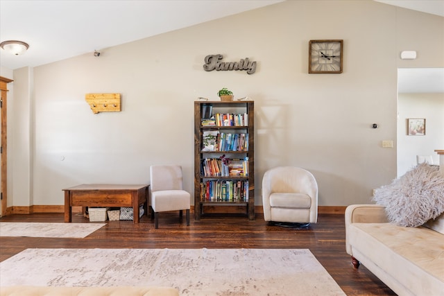 sitting room featuring dark wood-type flooring and vaulted ceiling