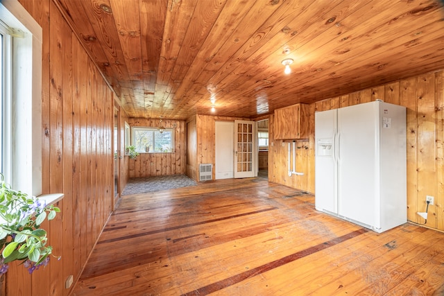 interior space with wooden walls, hardwood / wood-style flooring, and wooden ceiling