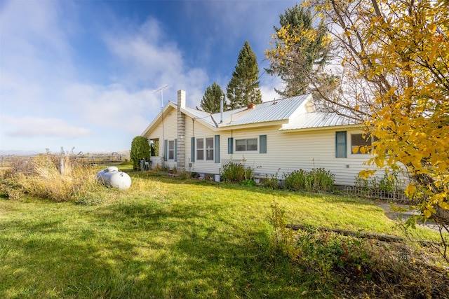 rear view of house featuring a yard