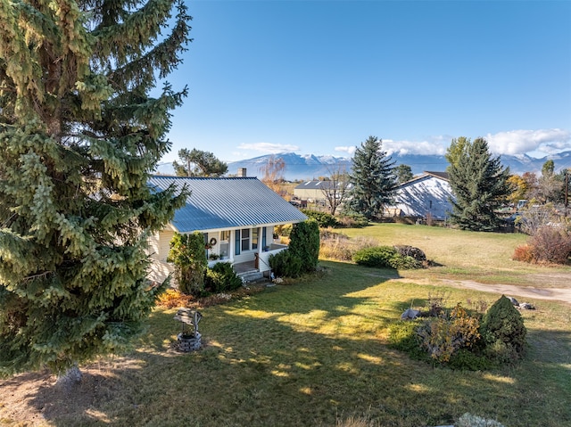 view of yard featuring a mountain view and a porch